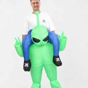 Adult wearing green inflatable ride-on alien costume with blue pretend rider legs