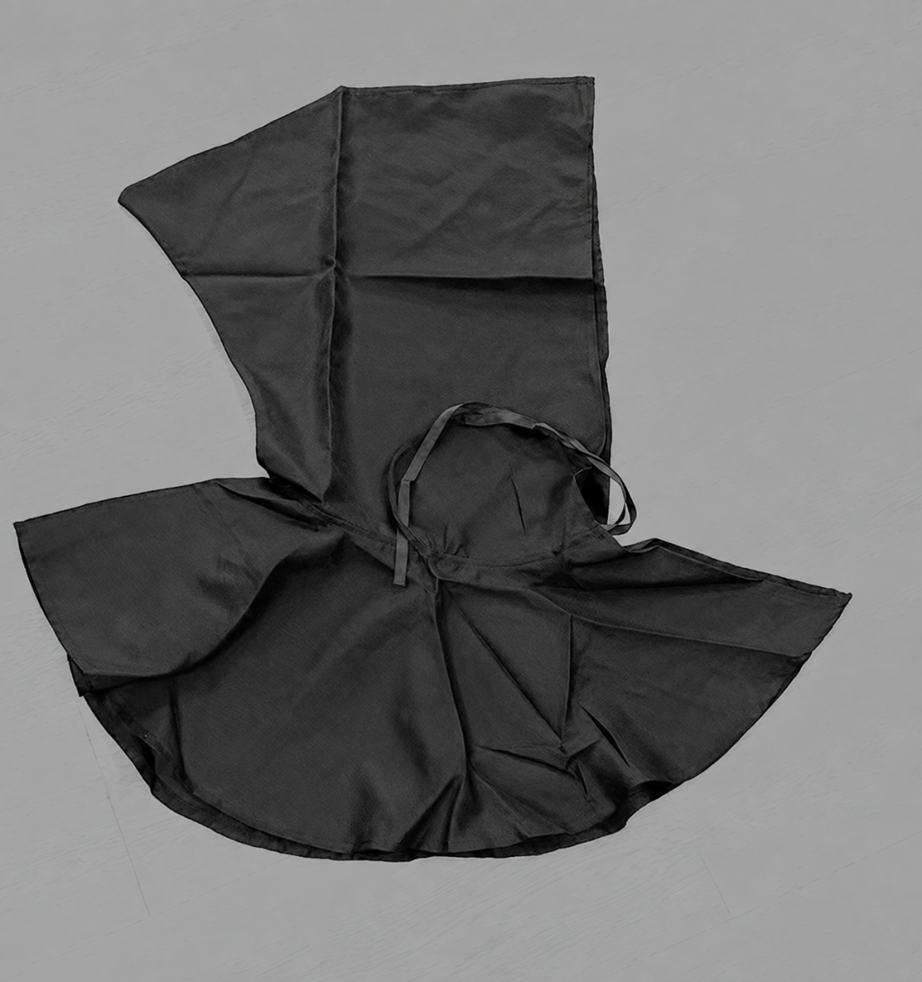 Black capelet laid flat to show hood panels and neck ties