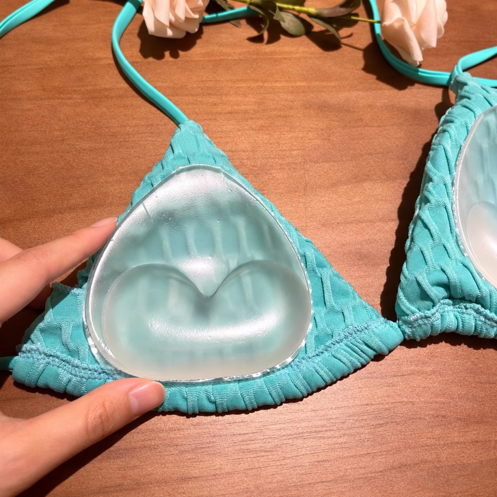 Clear silicone insert placed over a turquoise swimsuit cup