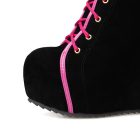 Rounded toe and pink piping on black wedge boot