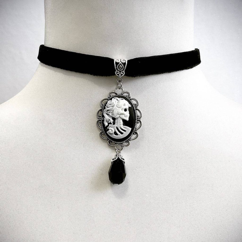 Skeleton cameo frame and black teardrop detail