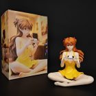 Seated Asuka figure beside illustrated display box