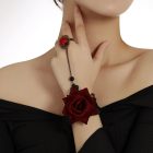 Red rose lace wrist accessory connected to a rose ring