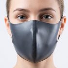 Gray fashion face covering worn, showing center seam