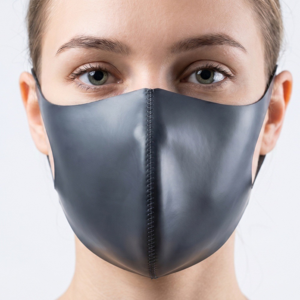 Gray fashion face covering worn, showing center seam