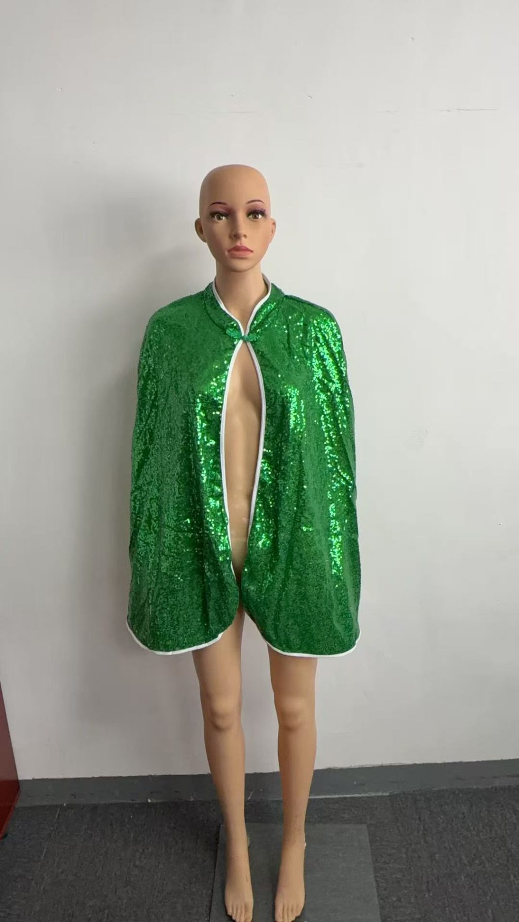 Green sequin cape front with contrast white edging and neck tie