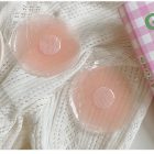 Flower-shaped pink adhesive cover pair on knit fabric