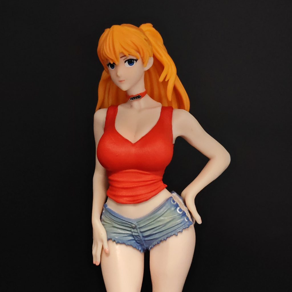 Close view of Asuka figurine with orange hair, red top and collar