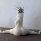 Rear view of the white seated split-pose planter