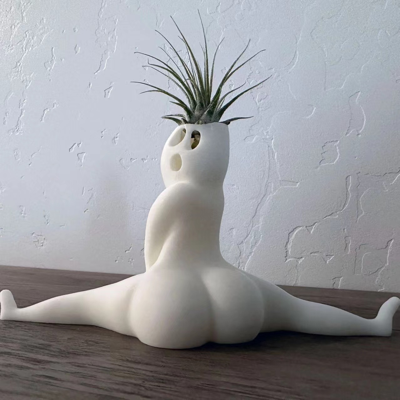 Rear view of the white seated split-pose planter