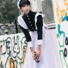 Black maid dress with white apron, buttoned collar and shoulder ruffles