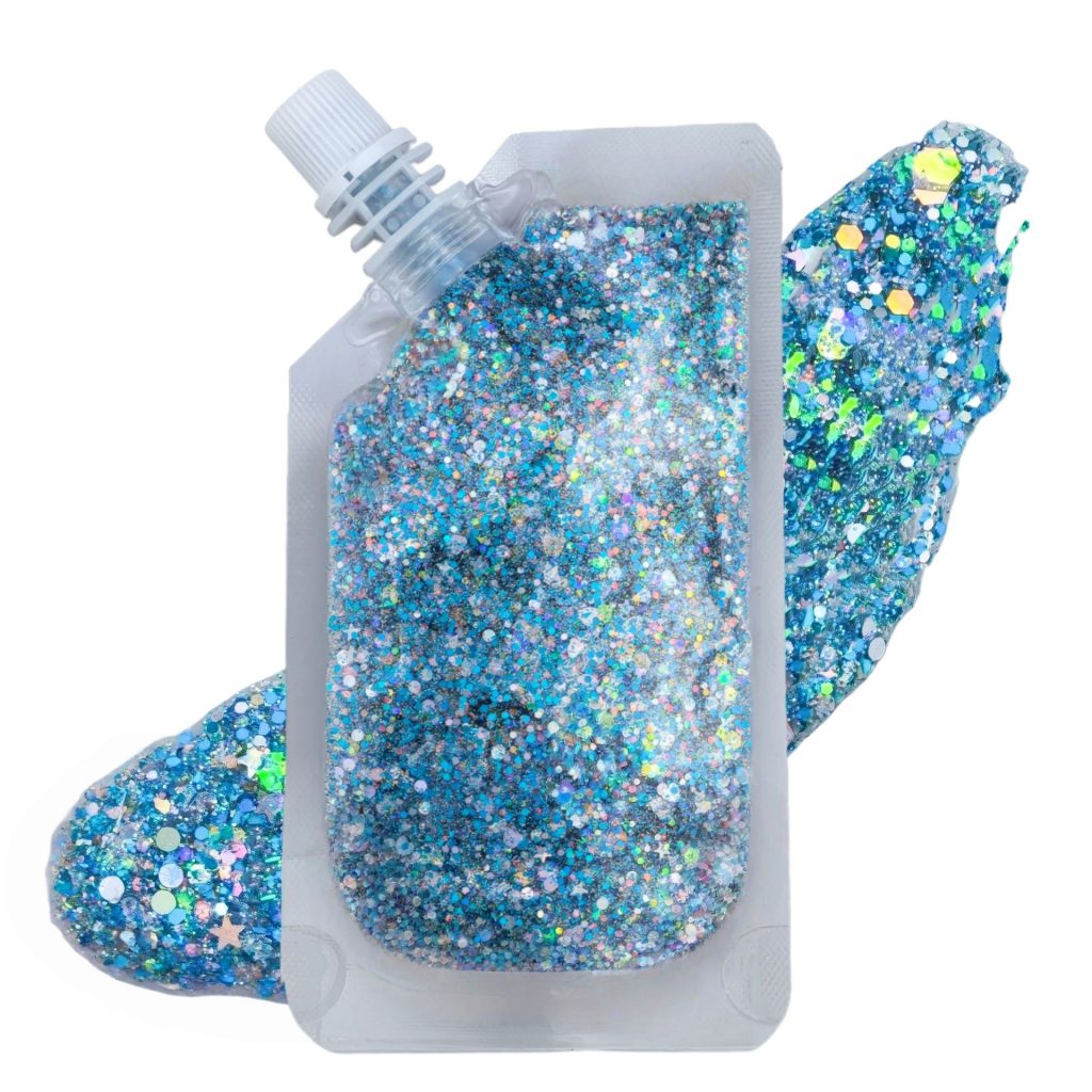 Blue cosmetic glitter gel in a capped pouch beside a gel swatch