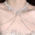 Silver rhinestone collar and chest drapes worn above a feathered neckline
