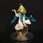 Three-quarter front view of Coco figure with raised pen, circular motif and round base