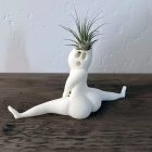 Side and rear angle of white split-pose planter on a tabletop