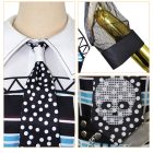 White collar, sheer sleeve and skull-print tie close-ups
