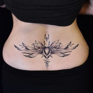 Black winged floral temporary tattoo across the lower back