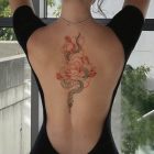 Flower and snake design shown on upper back
