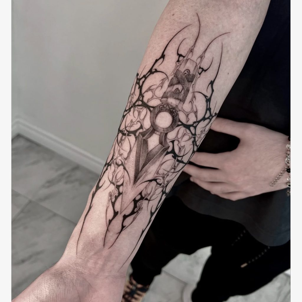 Gothic geometric emblem shown along forearm