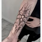 Gothic geometric emblem shown along forearm