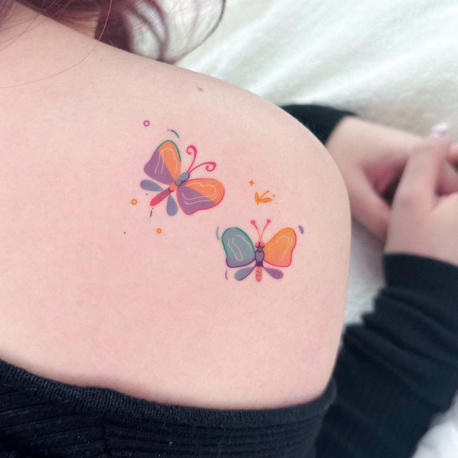 Pastel butterfly transfers shown on a shoulder