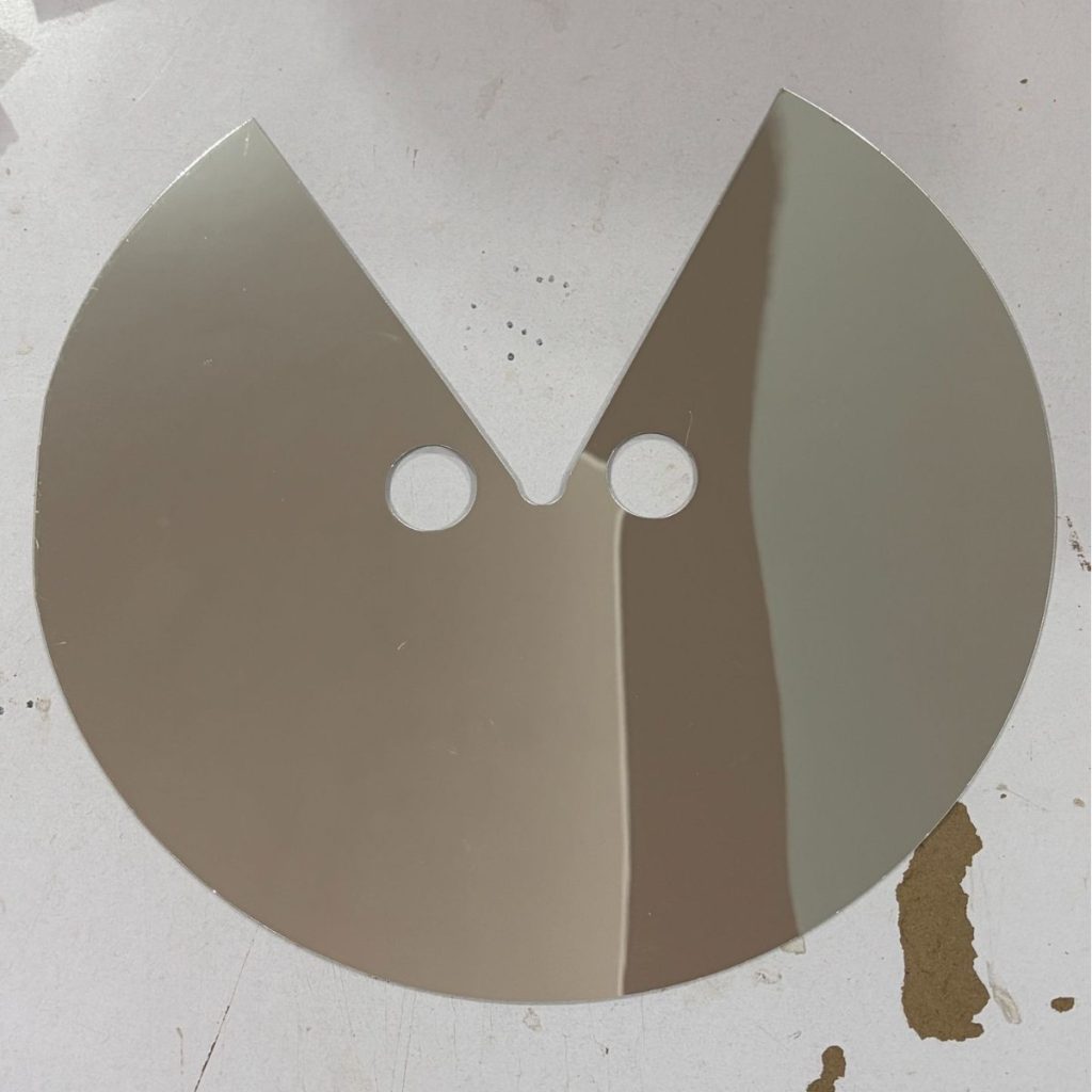 Reflective circular face prop with eye openings and V-shaped lower cutout