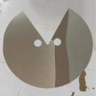 Reflective circular face prop with eye openings and V-shaped lower cutout