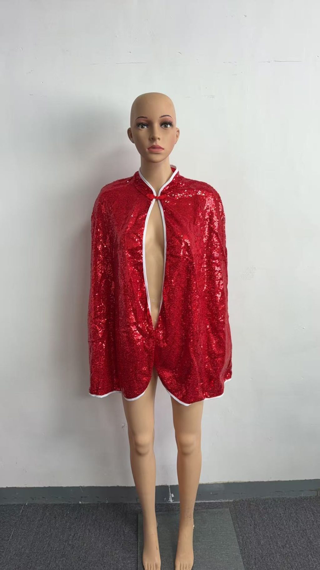 Red sequin cape front with contrast white edging and neck tie