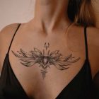 Winged floral temporary tattoo displayed across the upper chest