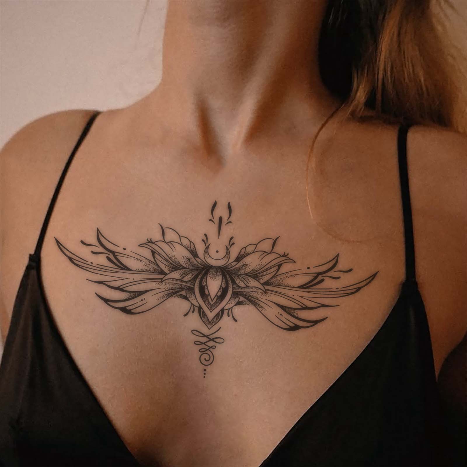 Winged floral temporary tattoo displayed across the upper chest