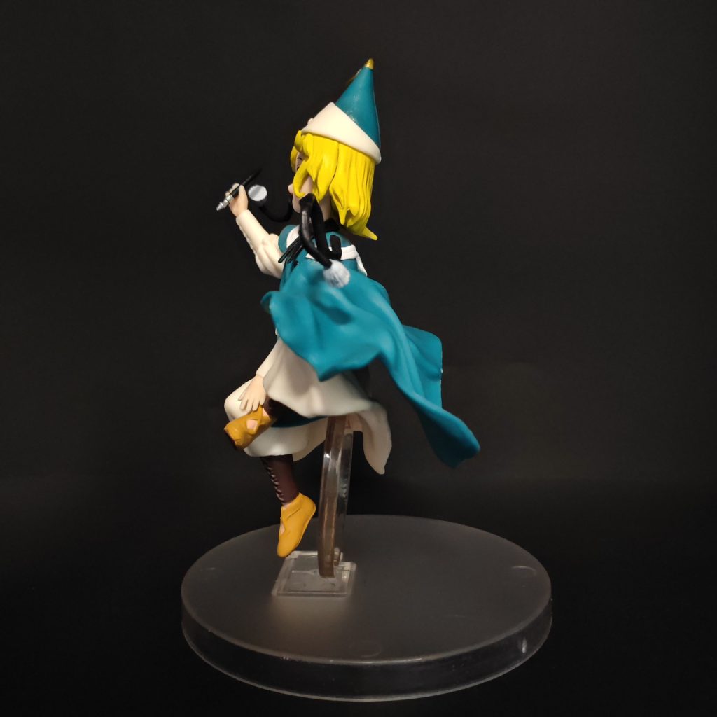 Side and rear view of Coco figurine showing cape folds and pointed hat