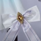 White waist bow with amber and gold jewel detail