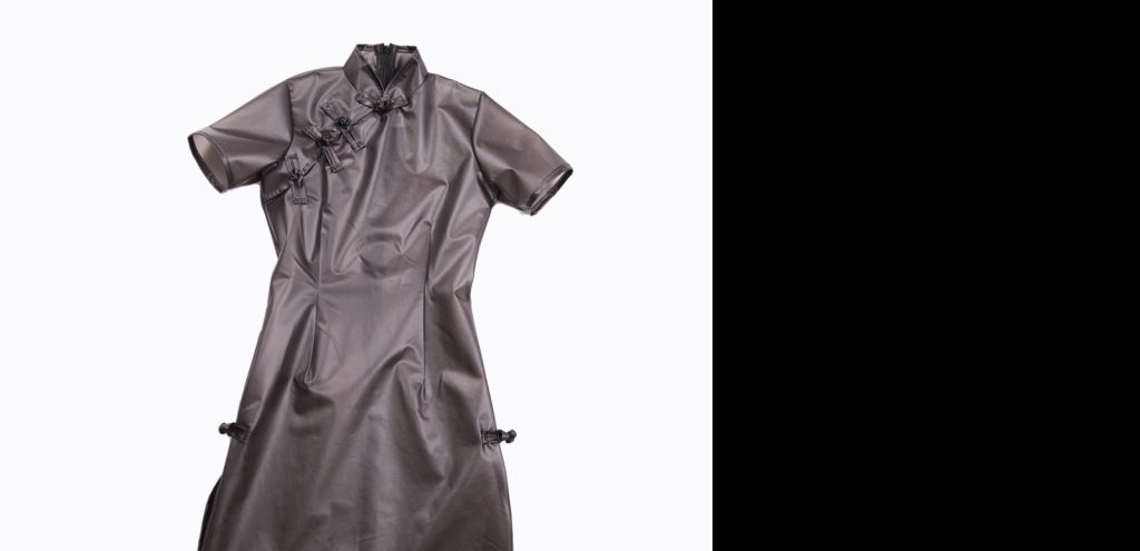 High neck and puff sleeve construction on black glossy dress