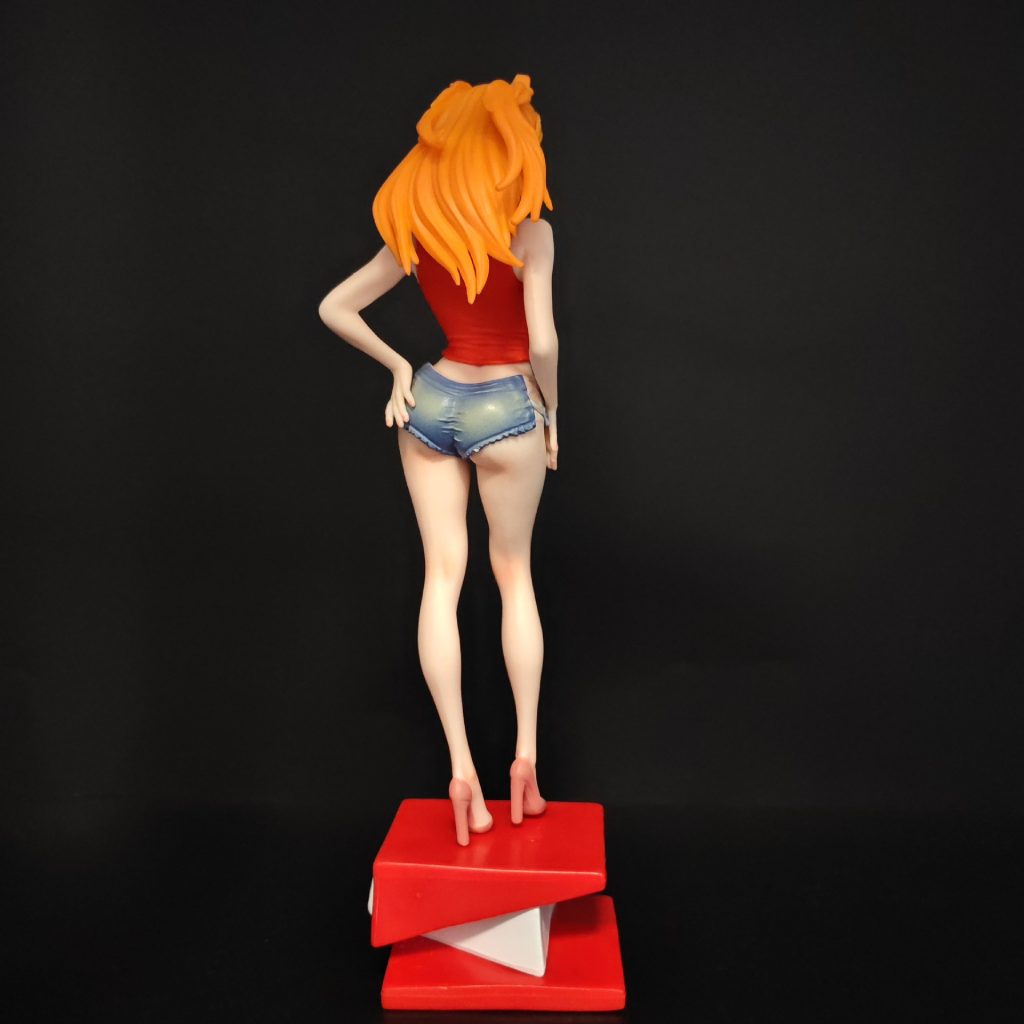 Asuka figurine seen from behind showing orange twin tails and blue shorts