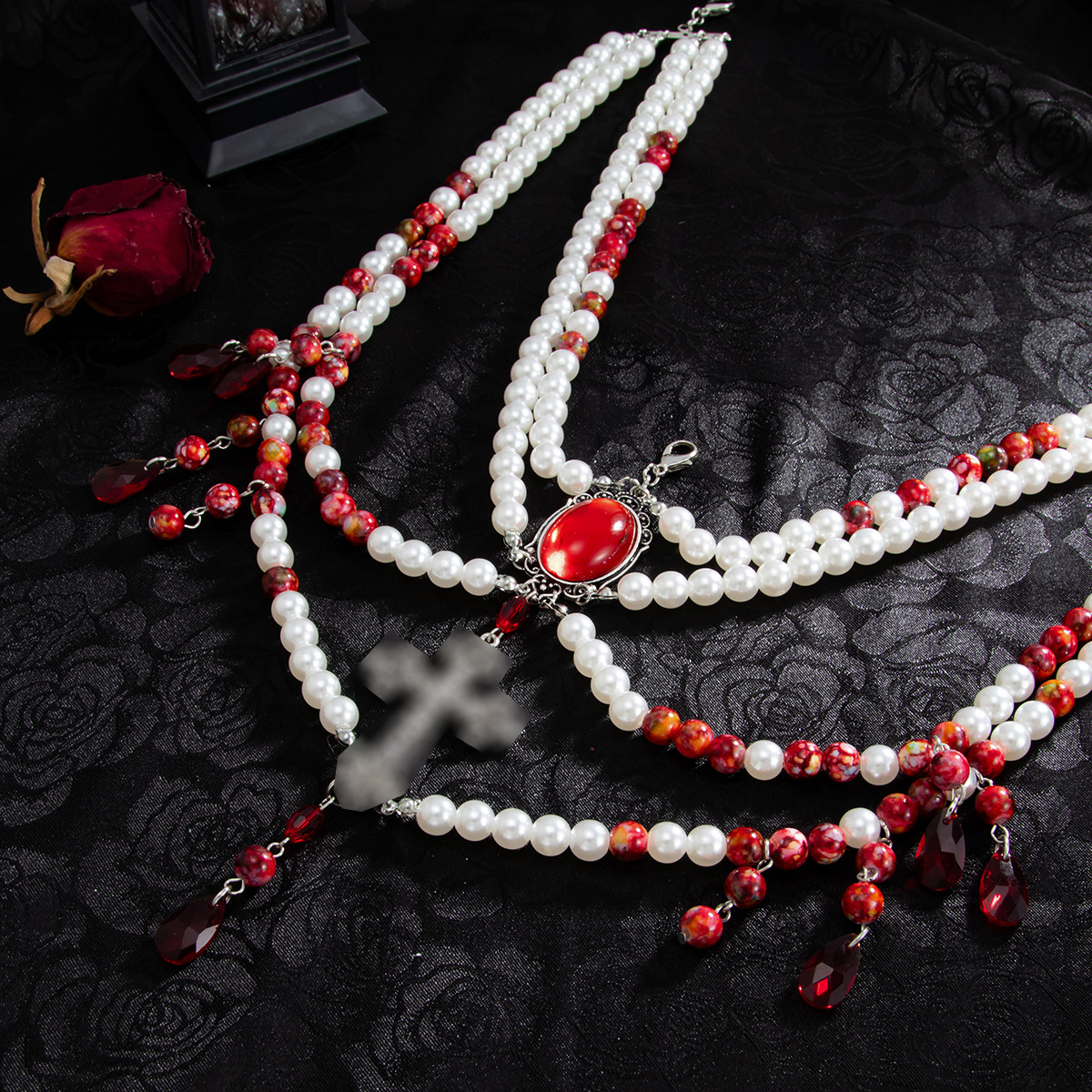 White cross red drops and layered bead clothing swag