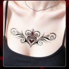 Black and red ornamental scroll temporary tattoo on chest