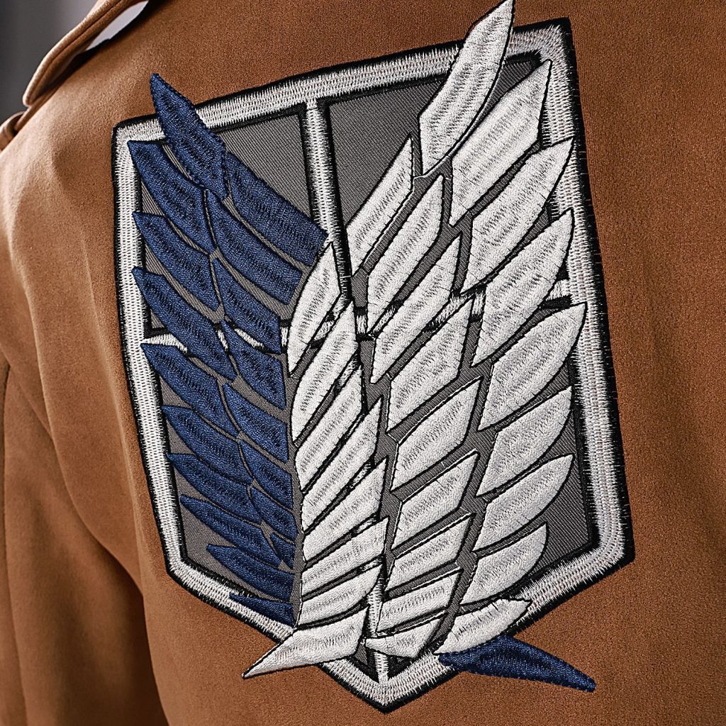 Blue-and-white wing insignia on brown Scout jacket