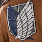 Blue-and-white wing insignia on brown Scout jacket