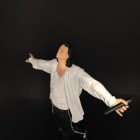 Singing pose figure with white shirt, microphone and black trousers