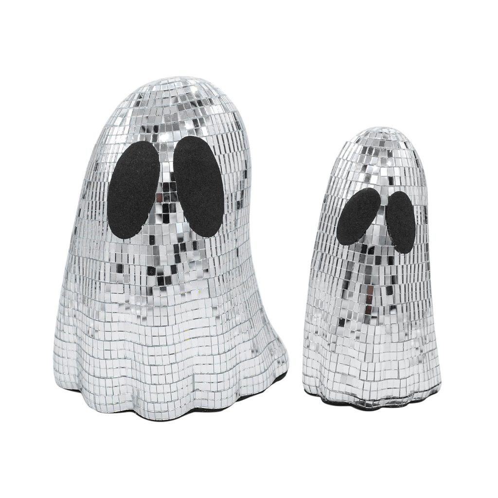 Two mirrored ghost ornaments reflecting warm surrounding light