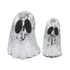 Two mirrored ghost ornaments reflecting warm surrounding light