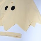 Angular cream cape hem and matching strap detail