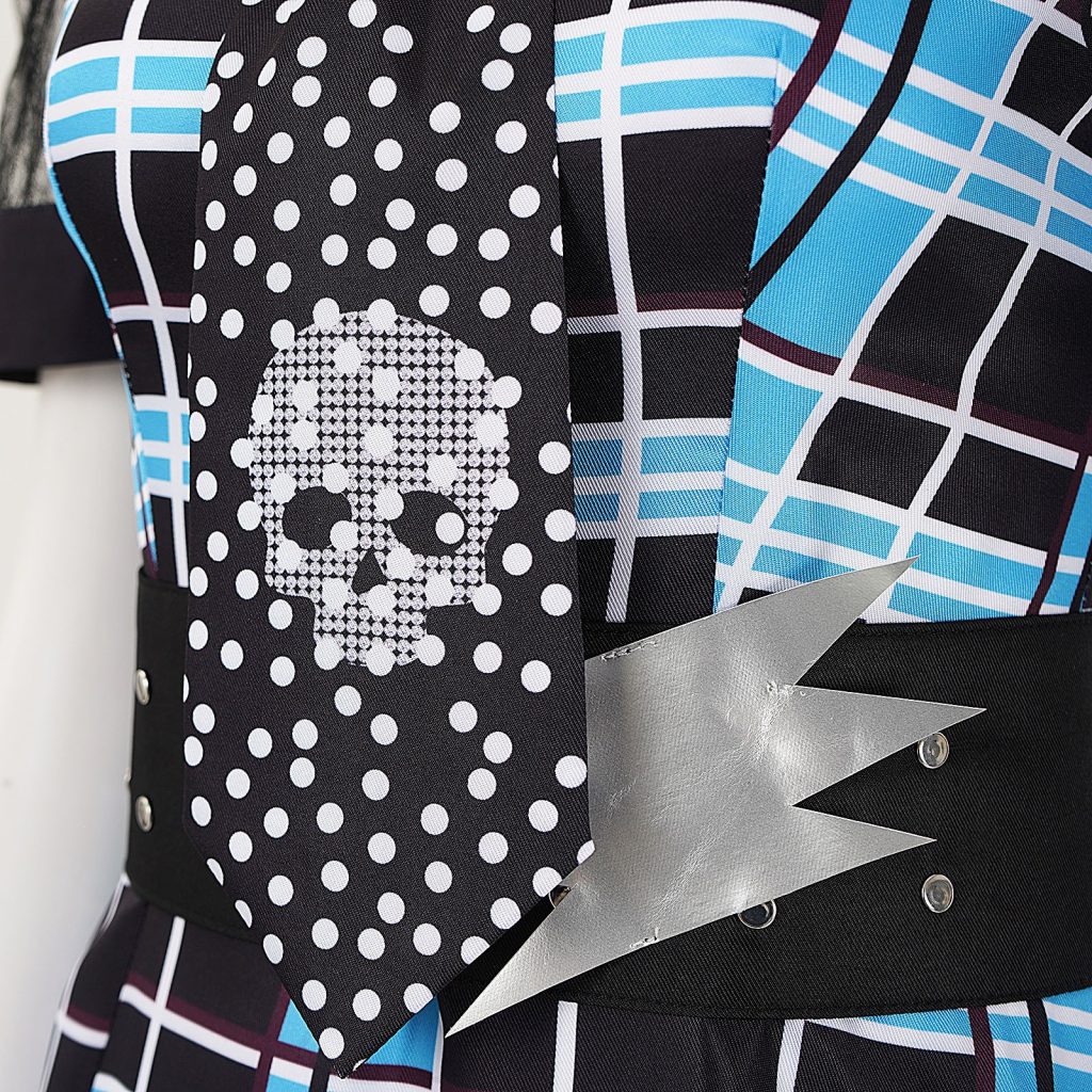 Close view of polka-dot skull tie and silver lightning detail on black waist belt