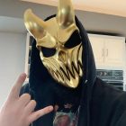 Gold skull mask styled with a dark hood
