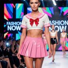 Pink skirt and red bow of sailor-inspired outfit on model