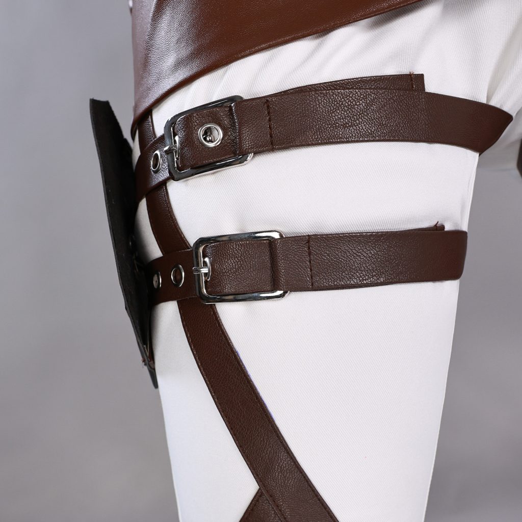 Buckled brown thigh straps over light trousers