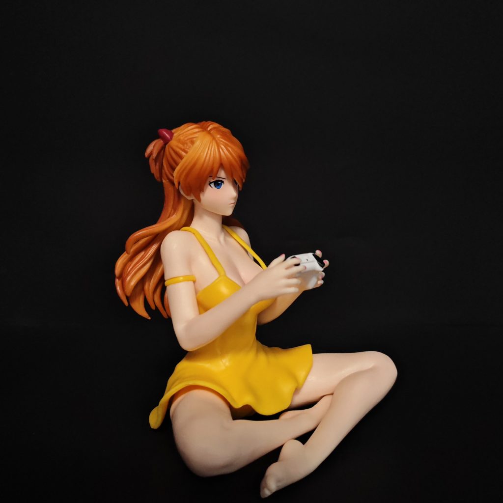 Right three-quarter view of Asuka figure holding the game controller