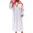 Model wearing a white robe and red-and-white headscarf with gold-tone chains, dollar-sign pendant, rings and bracelet, styled with sunglasses