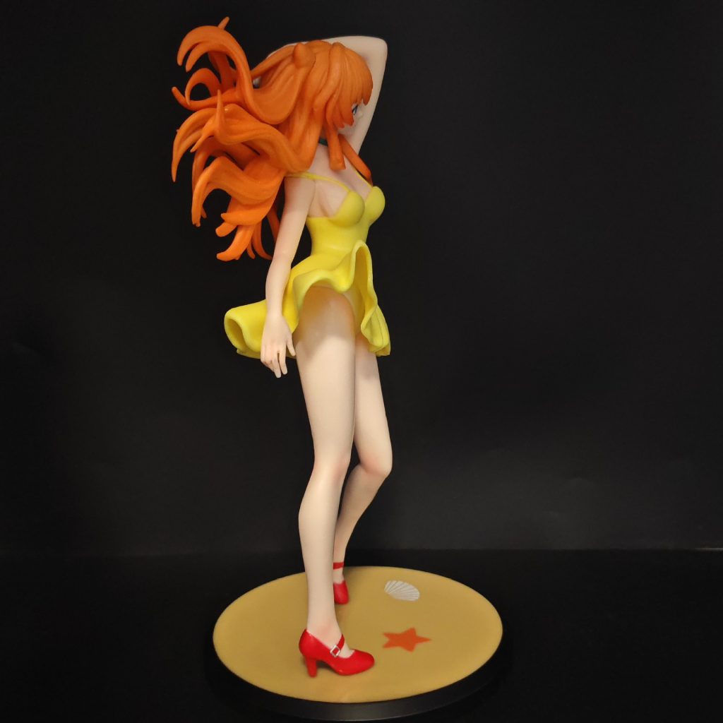Angled side view of Asuka's sculpted orange hair and yellow dress