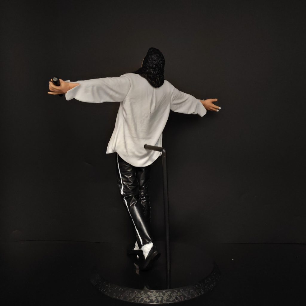 Rear of singing pose figure and display base